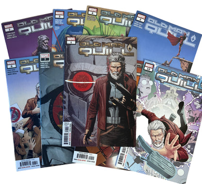 Comic books on a wooden surface with a person partially visible in the background.
