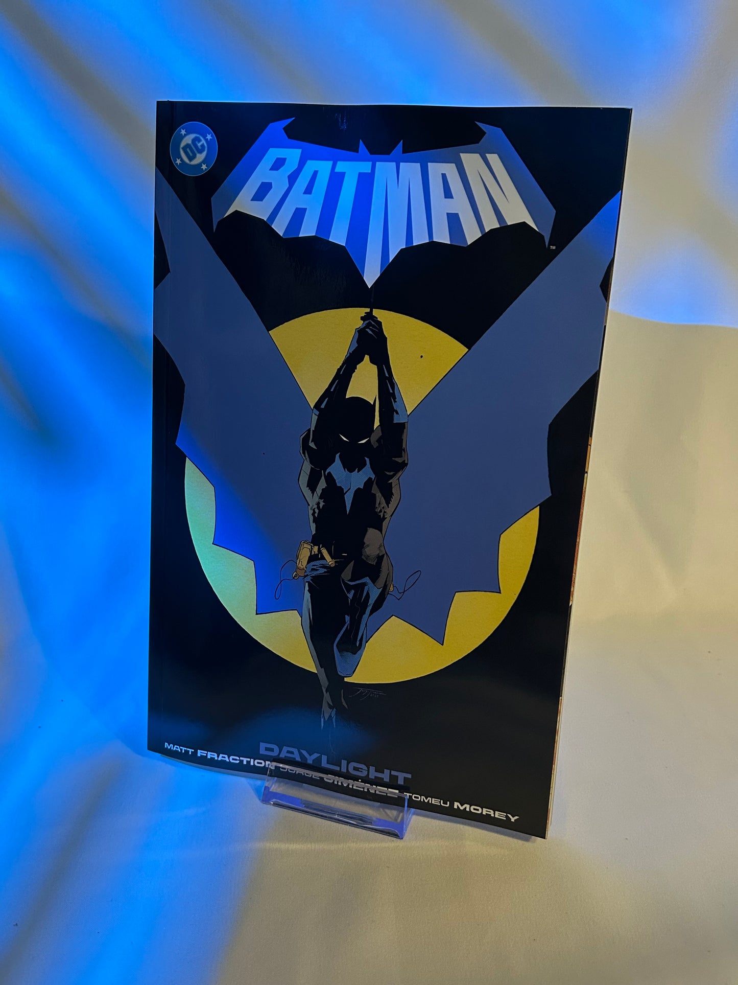 Batman logo on a product packaging with blue and yellow accents