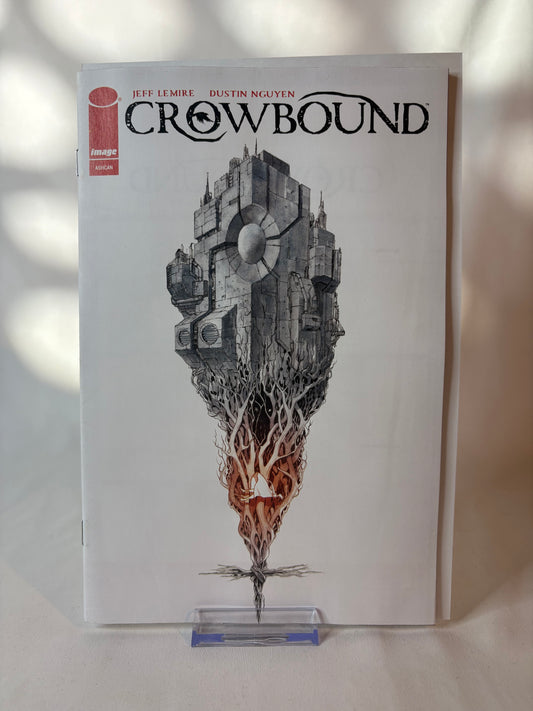 A copy of the graphic novel Crowbound by Jean-Lévy and Dustin Nguyen, featuring a white cover with a detailed black and gray illustration of a floating city and a fiery orange-red core, displayed on a clear acrylic stand.