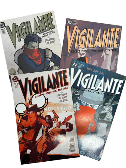 Four 'Vigilante' comic books on a wooden surface