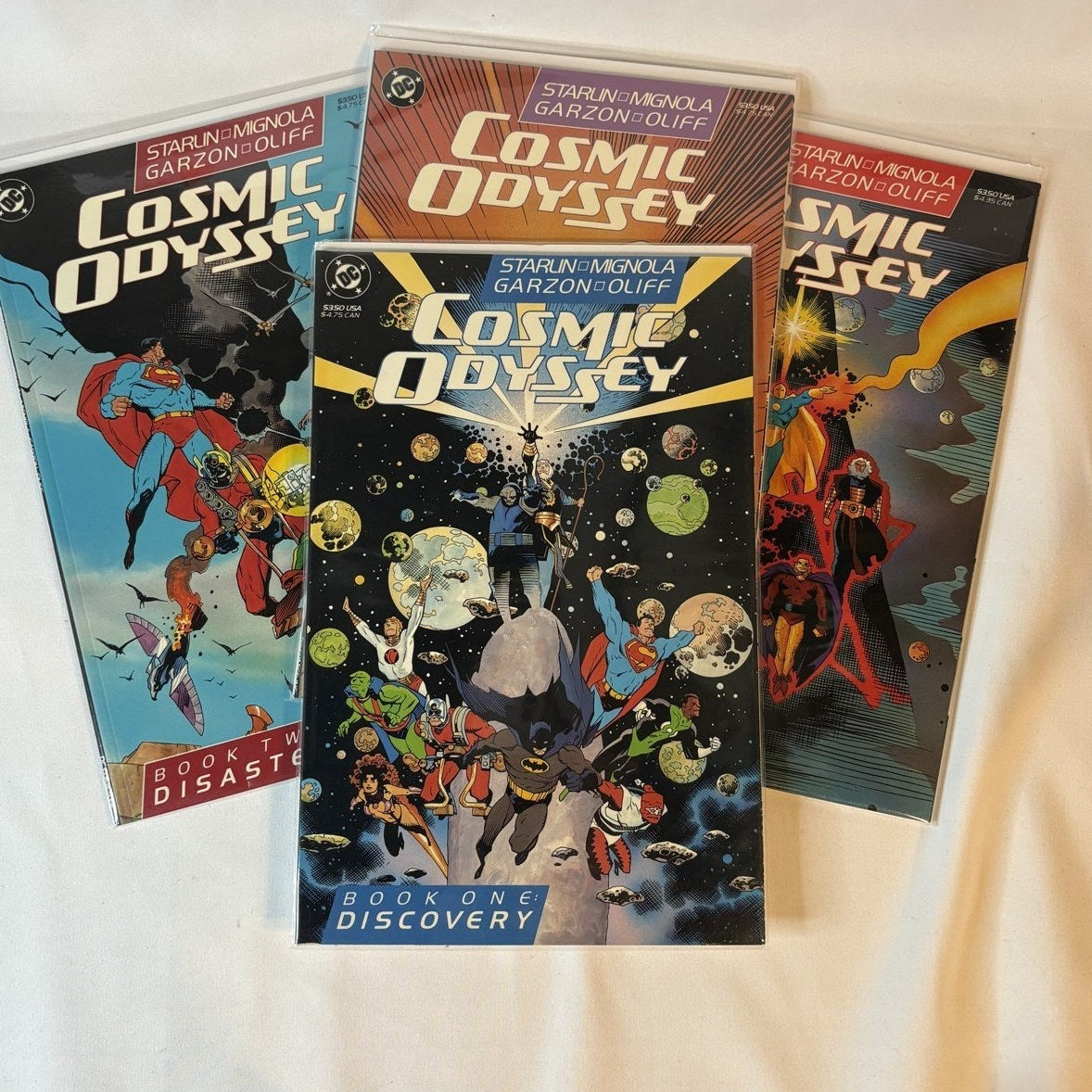 Cosmic Odyssey Books 1-4 complete set (DC 1988) by Starlin and Mignola, displayed as a group