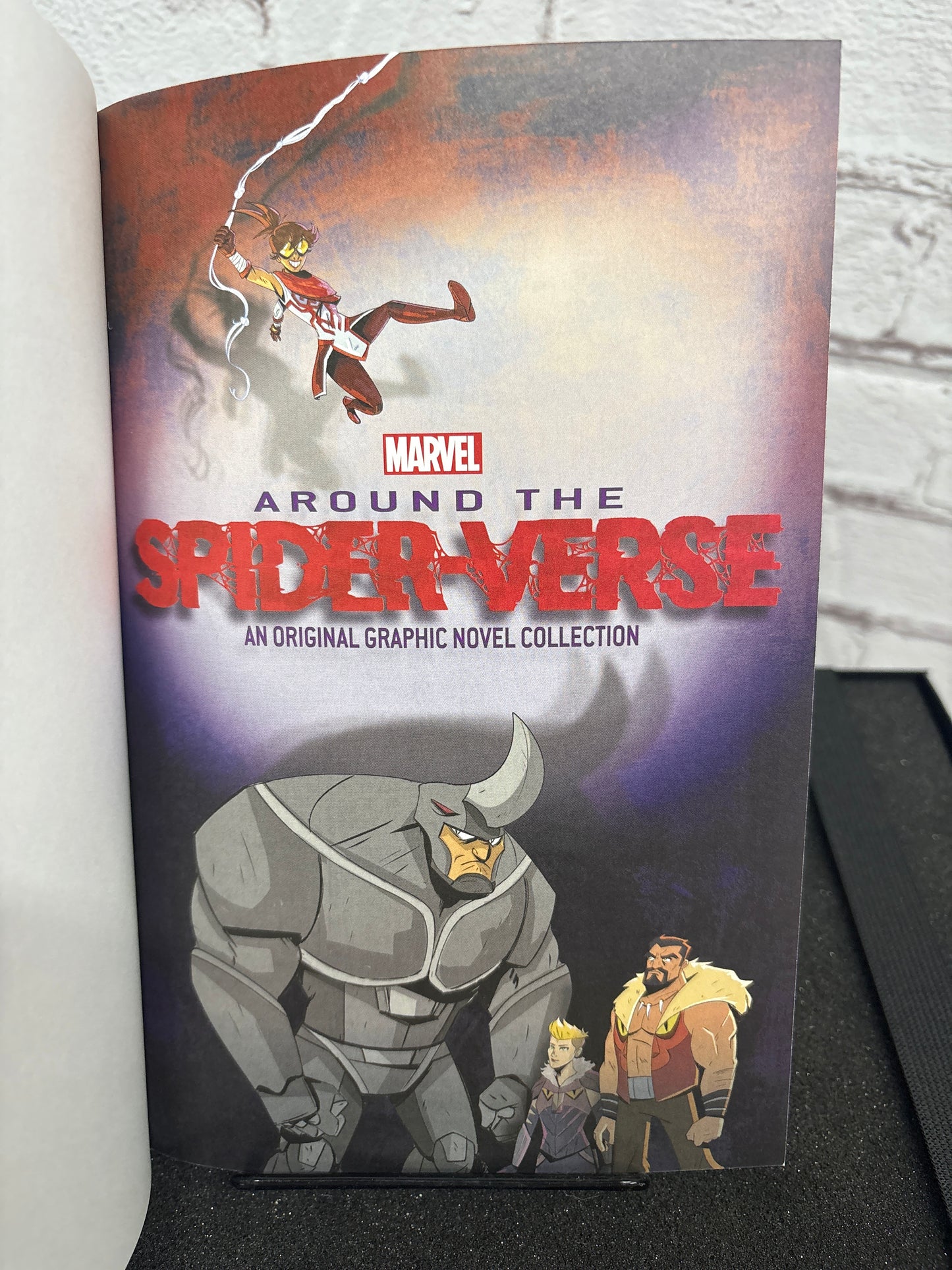 Marvel graphic novel collection titled 'Around the Spider-Verse' on a white surface with a gray background.