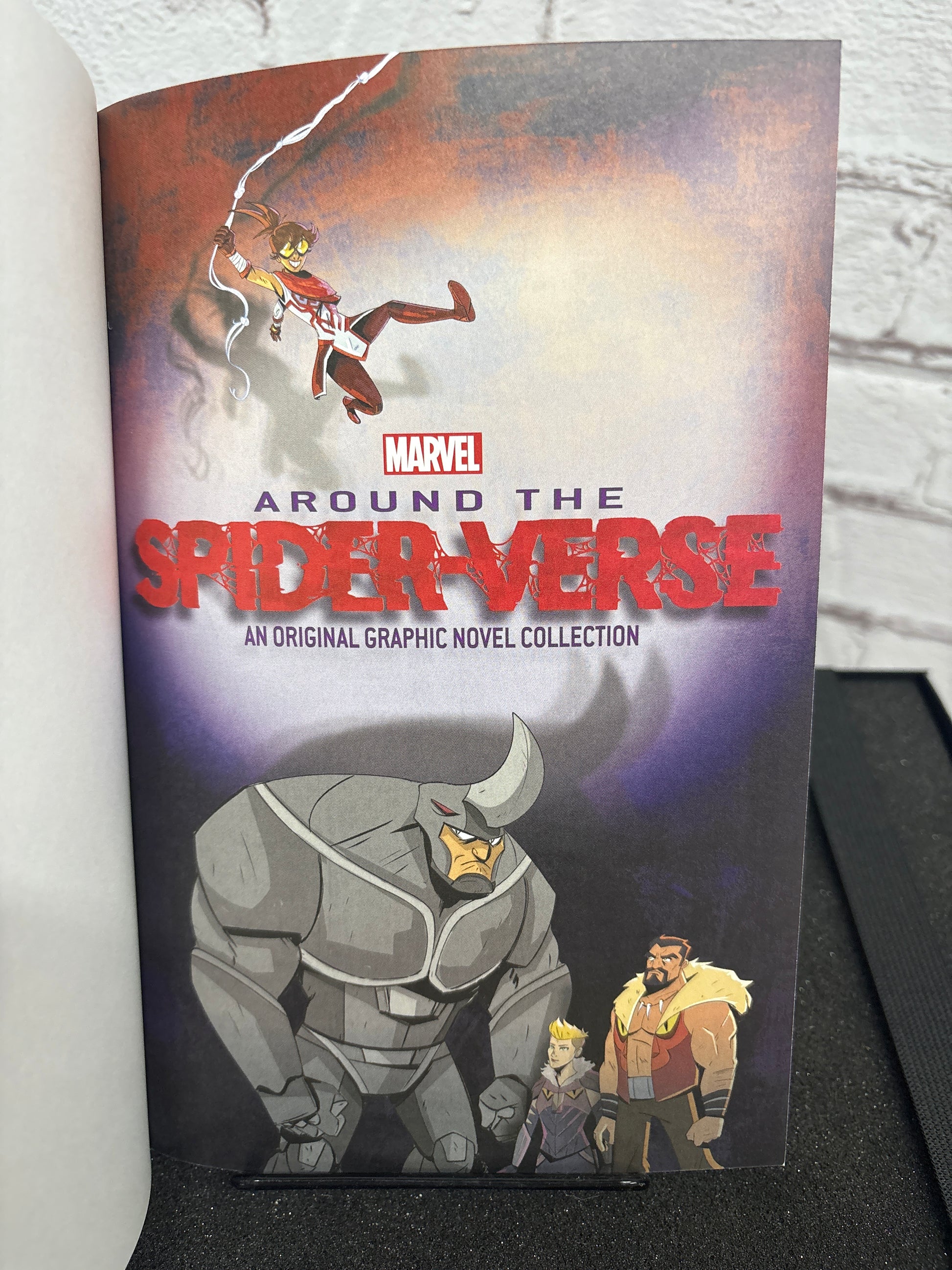 Marvel graphic novel collection titled 'Around the Spider-Verse' on a white surface with a gray background.