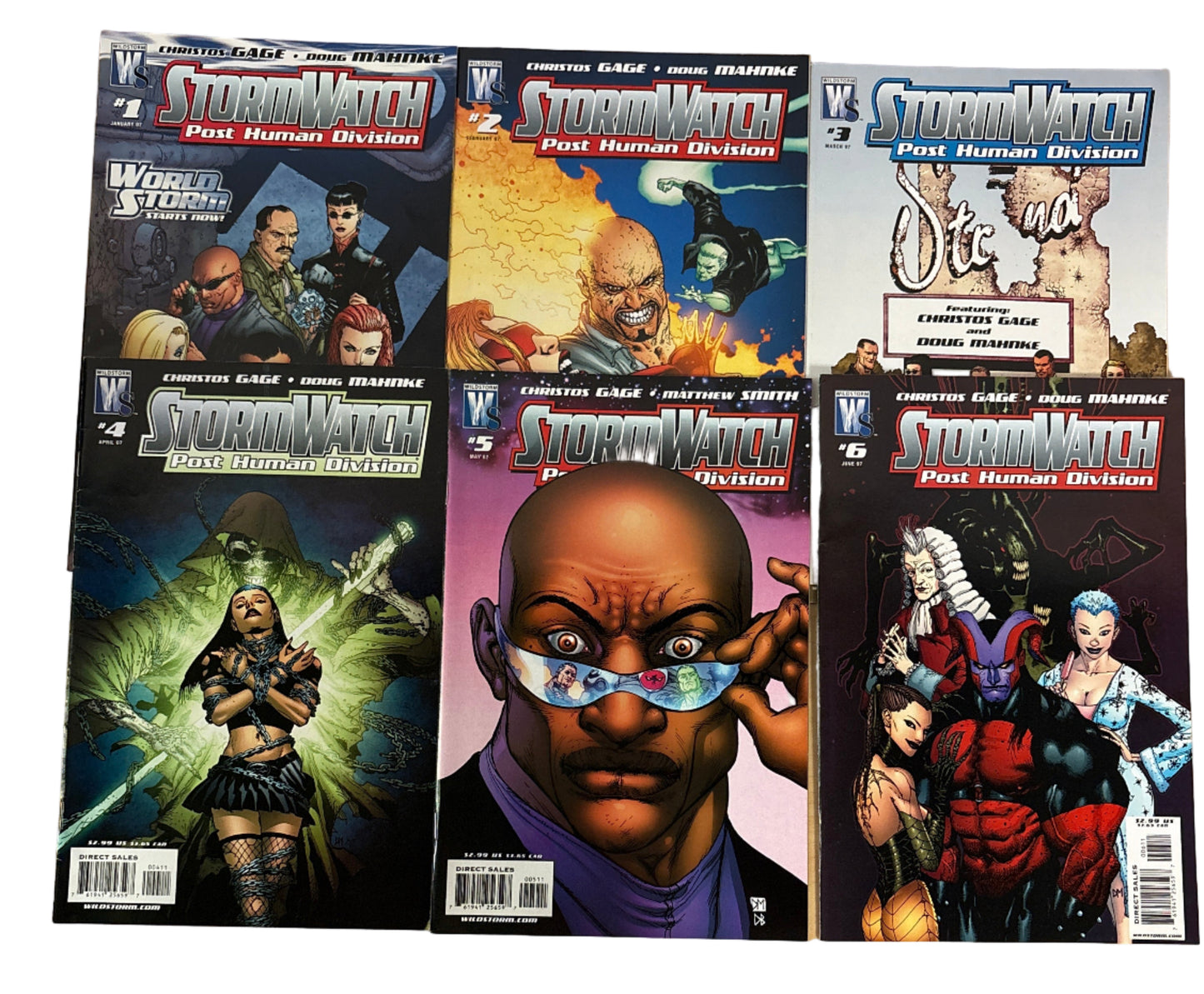 Collection of comic books on a wooden surface with a person partially visible.