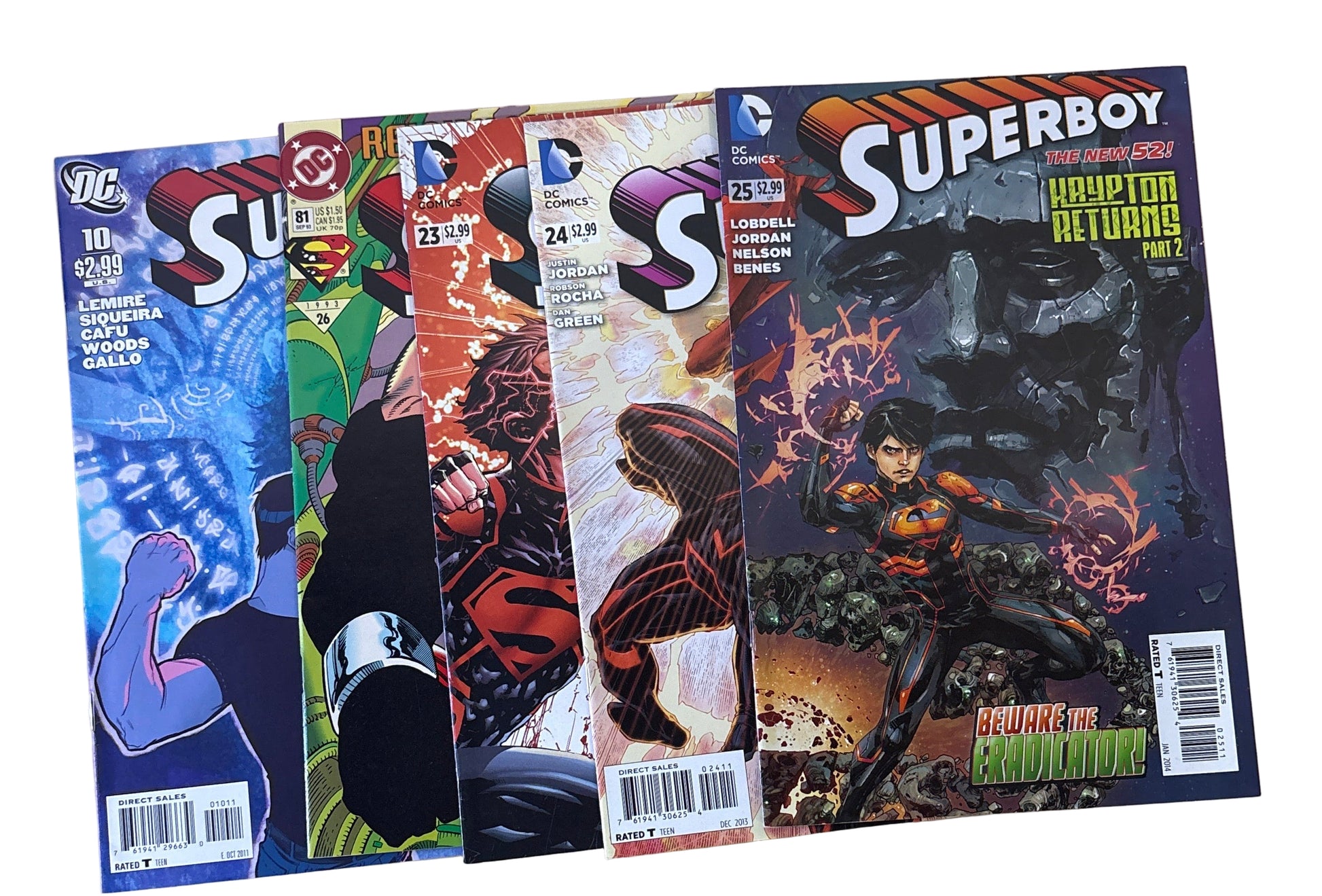 Three comic books titled 'Superboy' on a wooden surface.