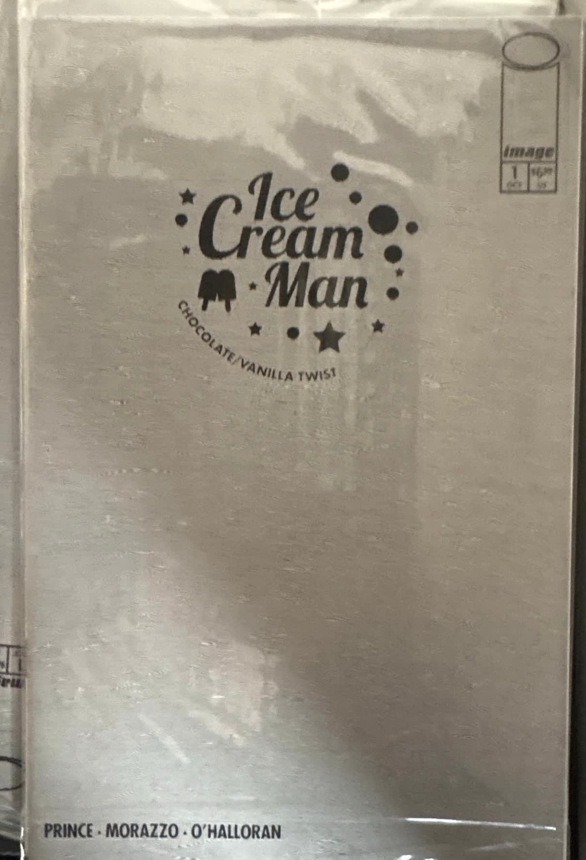 Ice Cream Man #1 Chocolate/Vanilla Twist in sealed polybag — silver decoder cover showing only the logo before the lens is applied