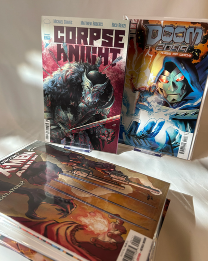 Stack of bagged and boarded superhero and indie comic books from the mystery bundle.
